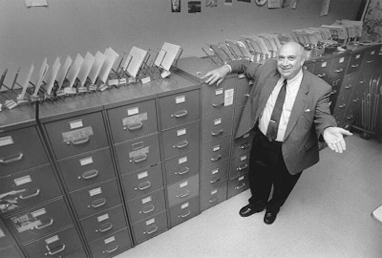 Alan Dundes standing next to archive